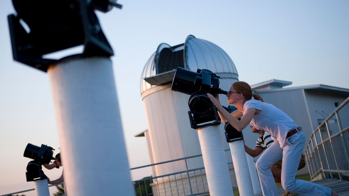 Student observing the stars with a telescope at the Texas A&amp;M Teaching Observatory.
