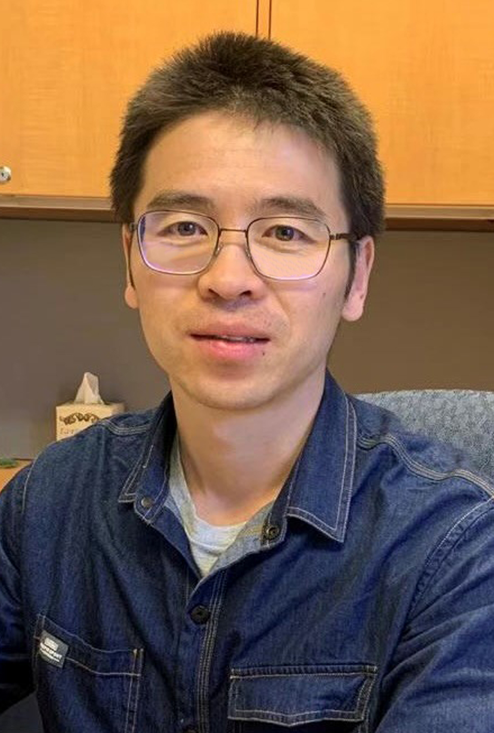 Texas A&M University physicist Baishan Hu, sitting in his office within the George P. Mitchell ’40 Physics Building on the Texas A&M campus.