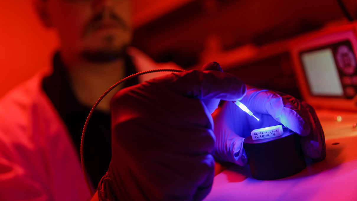 Researcher performing and experiment using ultraviolet light