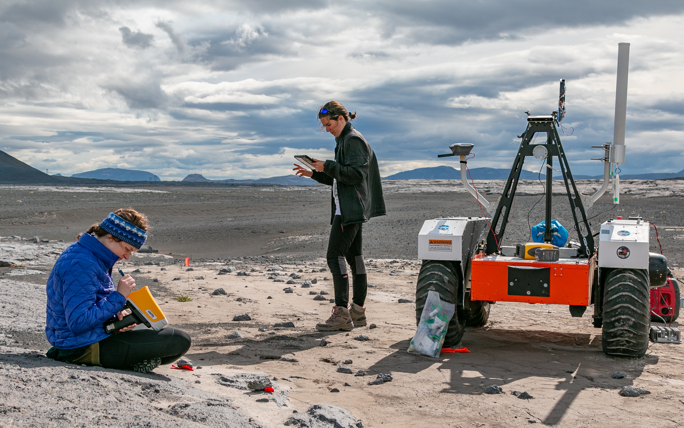 Two researchers with the remote controlled vehicle